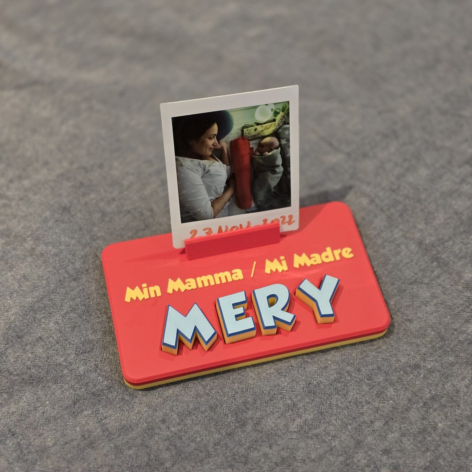 A name board spelling Mery with a photo standing in its holder